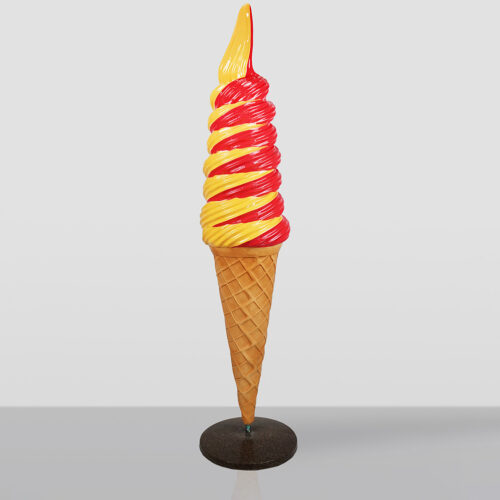Tall, swirled soft serve ice cream cone with alternating red and yellow colors, mounted on a black round stand against a plain light gray background