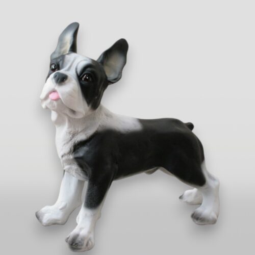 Statue of a black and white Boston Terrier dog with its tongue slightly out.
