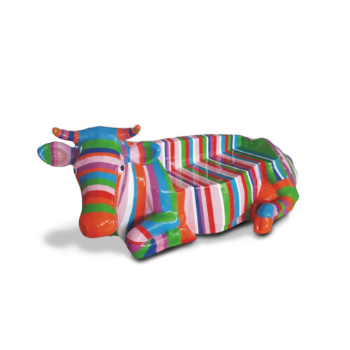 Colorful cow-shaped bench with multicolored stripes on a white background.