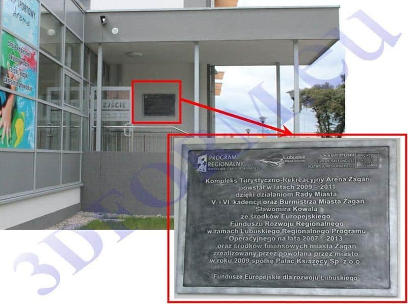 Building entrance with glass walls, a sign labeled 