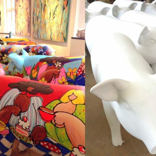 Colorful painted pig sculptures on the left juxtaposed with plain white pig sculptures on the right, displayed in an art gallery.