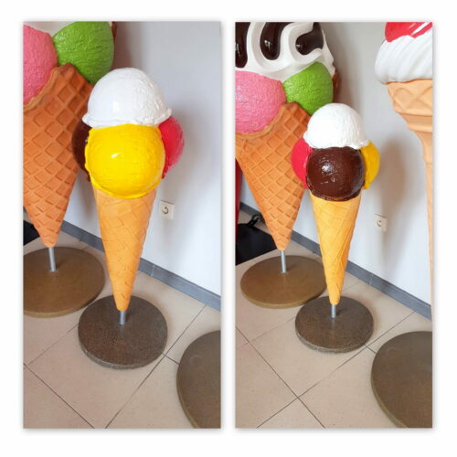 Large ice cream cone sculptures with scoops of different colors (yellow, white, brown, red) on a stand.