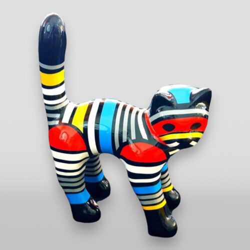 Colorful cat sculpture with striped patterns in black, white, yellow, blue, and red.