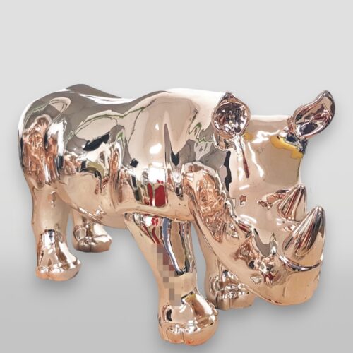 Golden rhino figurine with a reflective surface.