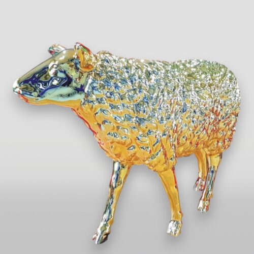 Chrome sheep sculpture with golden accents against a light gray background.