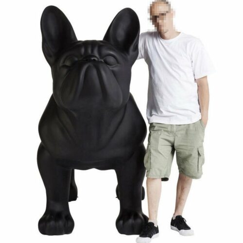A standing man with a pixelated face poses next to an oversized black bulldog statue on a white background.