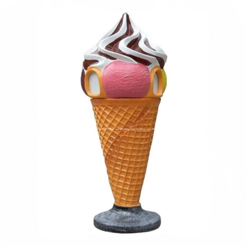 Statue of an ice cream cone with a waffle cone base, pink scoop, vanilla and chocolate swirl on a stand.
