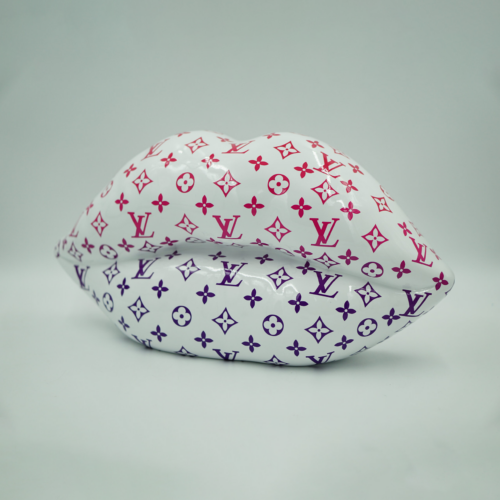 A white, lips-shaped sculpture with pink and purple Louis Vuitton monogram patterns.