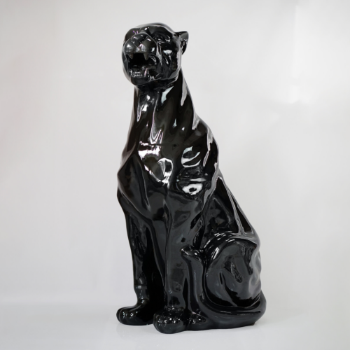 Black glossy ceramic figurine of a sitting panther on a white background.