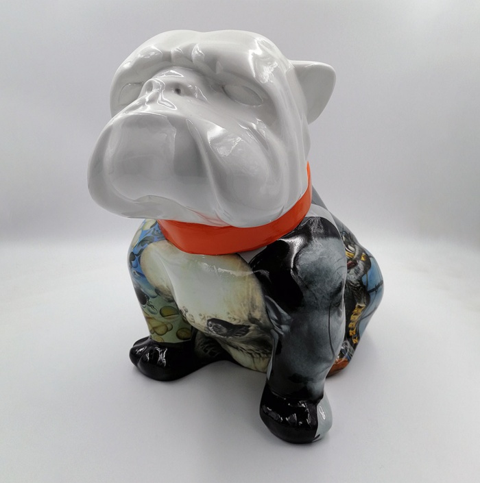 Ceramic bulldog figurine with a glossy white head and an artistic, multicolored body, wearing an orange collar.