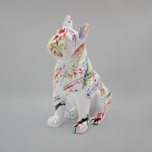 Statue of a French Bulldog covered in multicolored paint splatters.