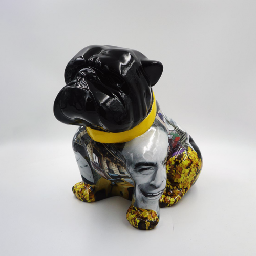 Ceramic pug statue with a glossy black head, wearing a yellow collar, and a body covered in a collage of various images including a face, buildings, and yellow flowers.