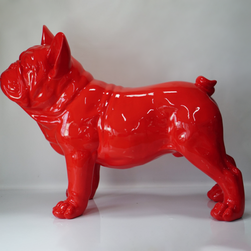 Red glossy statue of a standing bulldog on a white background.