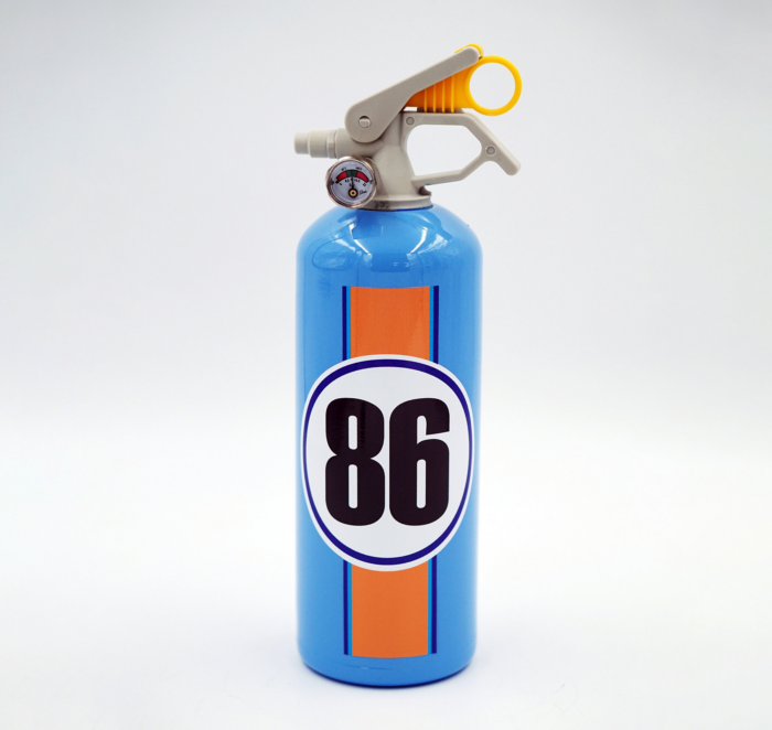 Blue fire extinguisher with an orange stripe and the number 86 on the front.