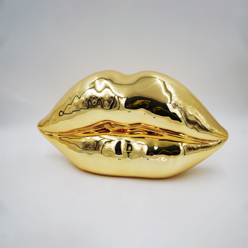 A golden sculpture in the shape of lips.