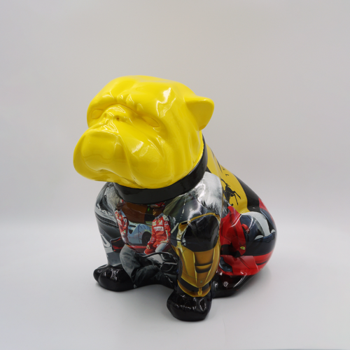 Colorful bulldog sculpture with a yellow head and multicolored body, featuring various designs and patterns.