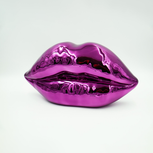 Purple metallic lips sculpture against a white background.