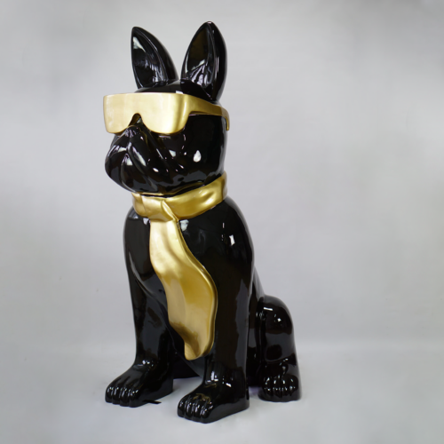 A glossy, black ceramic sculpture of a dog wearing gold sunglasses and a gold tie is set against a plain white background.