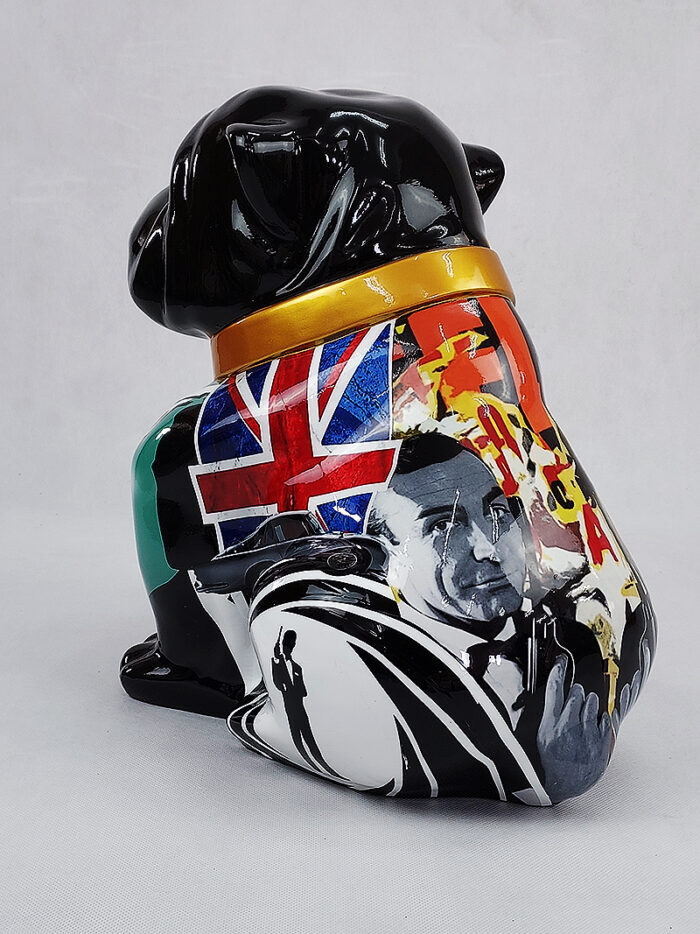 A black ceramic dog figurine decorated with a collage of images, including a Union Jack flag and a portrait of a man in a suit holding a gun.