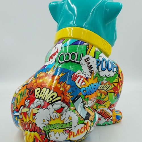 A colorful, cartoon-style bulldog sculpture with a turquoise head and yellow collar, covered in comic book sound effects like 