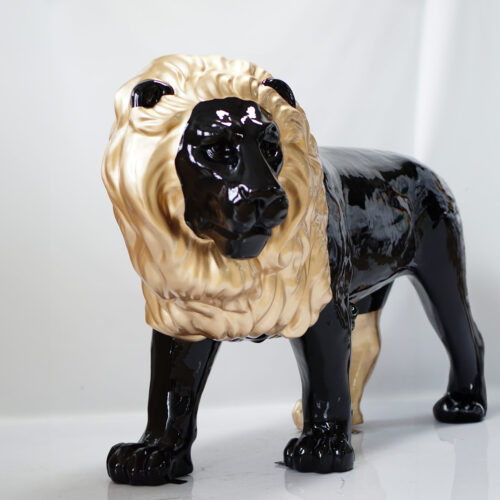 Statue of a lion with a black body and a golden mane.