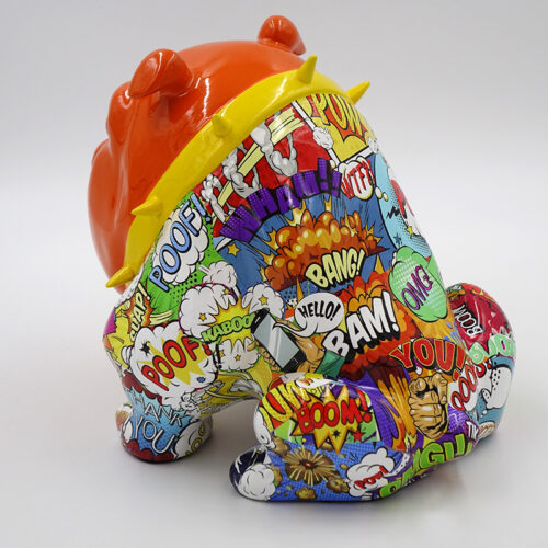 A colorful sculpture of a frog with an orange head and a body covered in comic book-style graphics and expressive words like