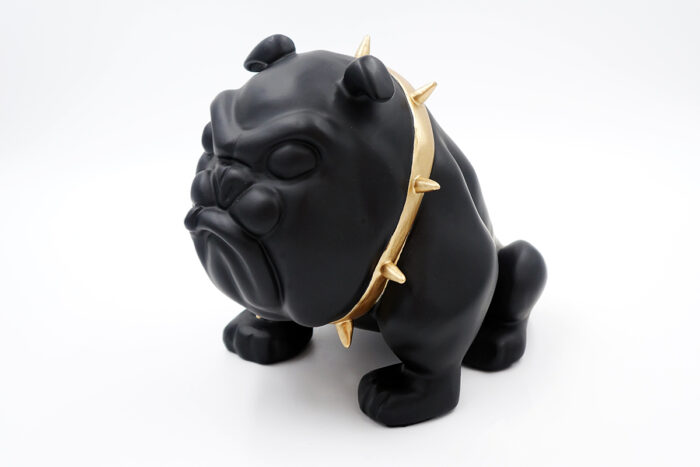 Black bulldog figurine wearing a gold spiked collar.