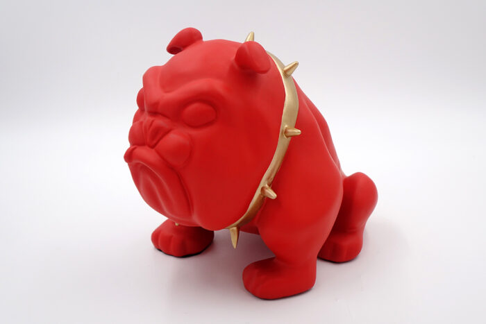 Red bulldog figurine with a gold spiked collar