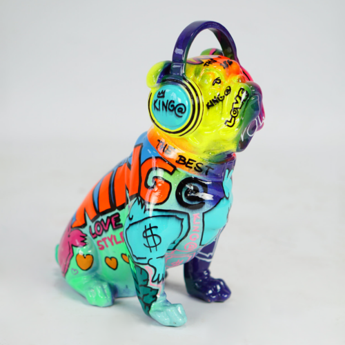Colorful bulldog figurine wearing headphones with graffiti-style text and designs.