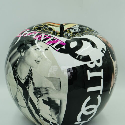 Decorative apple-shaped sculpture with black and white photos, including a vintage image of a woman, and