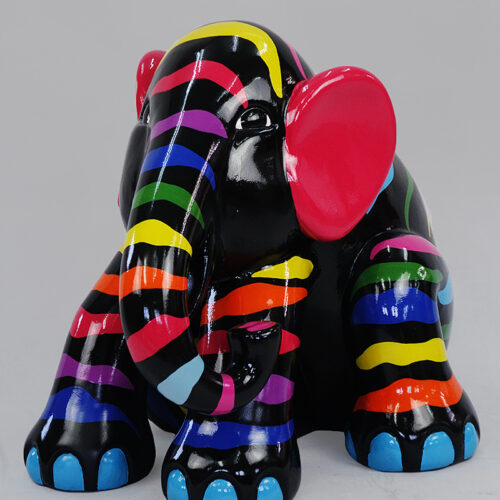 Colorful elephant sculpture with black base color, multicolored stripes, bright red ears, and blue feet.