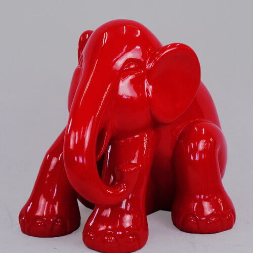 Red glossy elephant figurine with a reflective surface against a plain background.