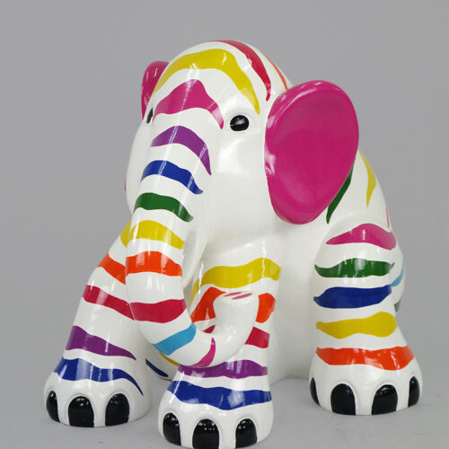 Colorful elephant figurine with rainbow stripes and pink ears.