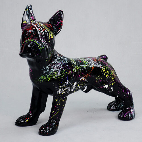 Artistic statue of a dog painted black with colorful splatters and streaks of neon paint.