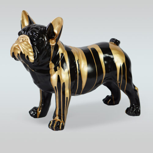 A black statue of a French Bulldog with golden streaks running down its body.