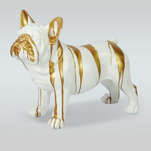 White ceramic bulldog sculpture with gold paint drips.