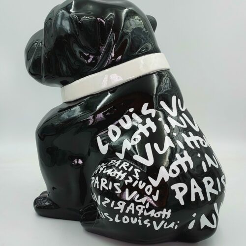 Black ceramic dog figurine with white graffiti-style text reading 