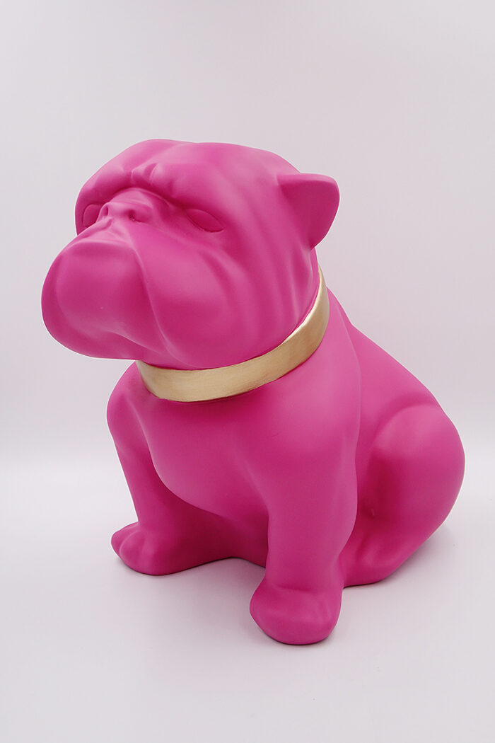 Pink bulldog statue with a gold collar.