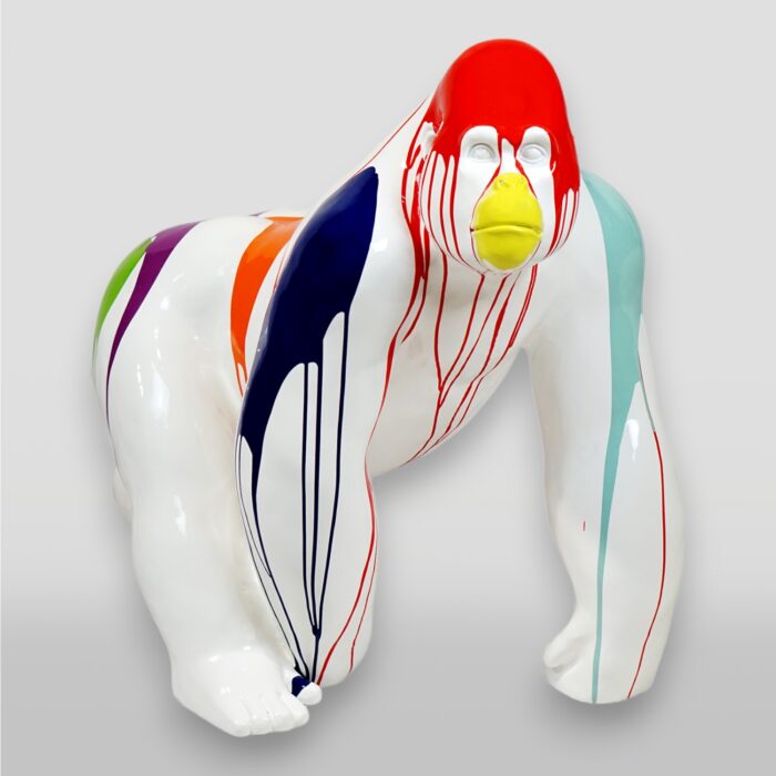 Colorful gorilla sculpture with dripping paint in red, orange, yellow, blue, green, and teal on a white body.