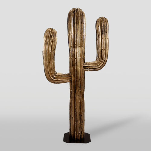 A metallic gold sculpture of a saguaro cactus on a black base.
