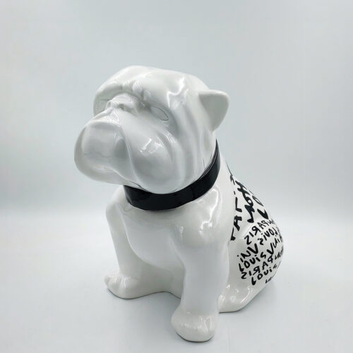 White ceramic bulldog figurine with black collar and letters on its back.