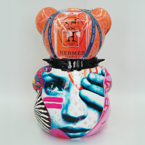 Colorful bear figurine with an artistic design featuring the brand