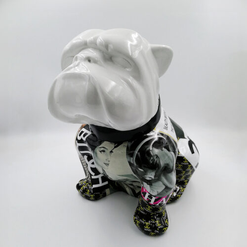 Ceramic bulldog statue with a glossy white head and body covered in black and white magazine clippings and images.
