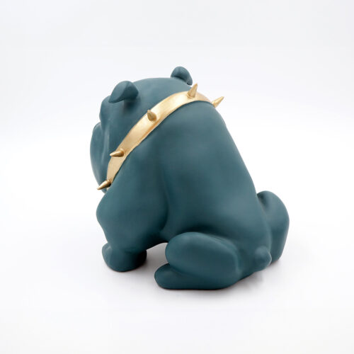 A navy blue bulldog figurine wearing a gold spiked collar sitting on a white surface.