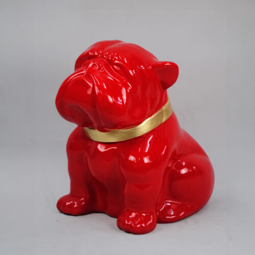 Red bulldog statue with a gold collar.