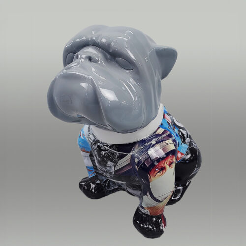 A ceramic bulldog sculpture with a gray head and a colorful, glossy body featuring various images and patterns.