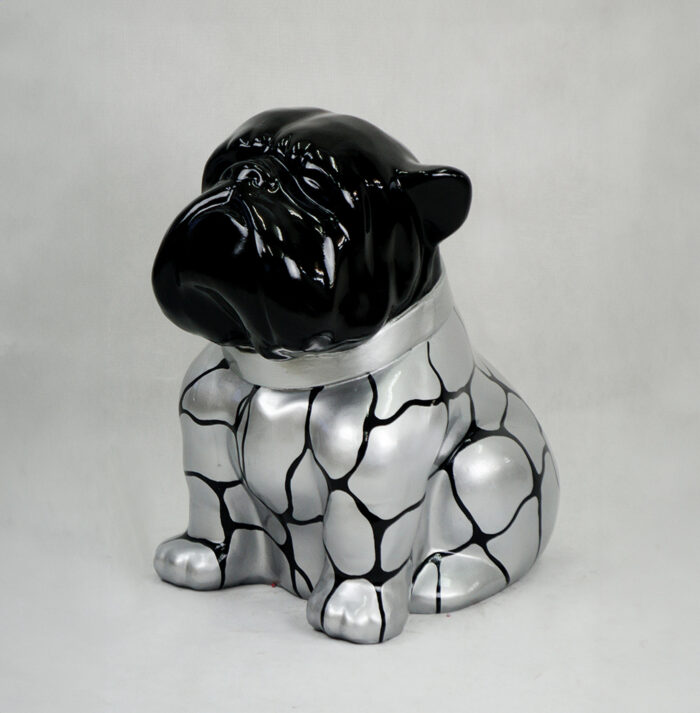 Statue of a dog with a shiny black head and a silver body with a black cracked pattern.