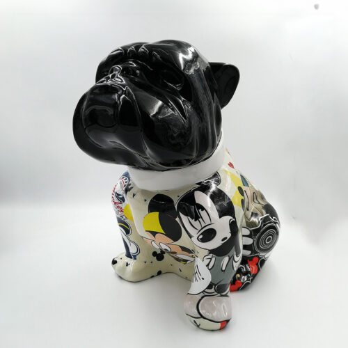 Sculpture of a bulldog with a glossy black head and a colorful, cartoon-covered body.