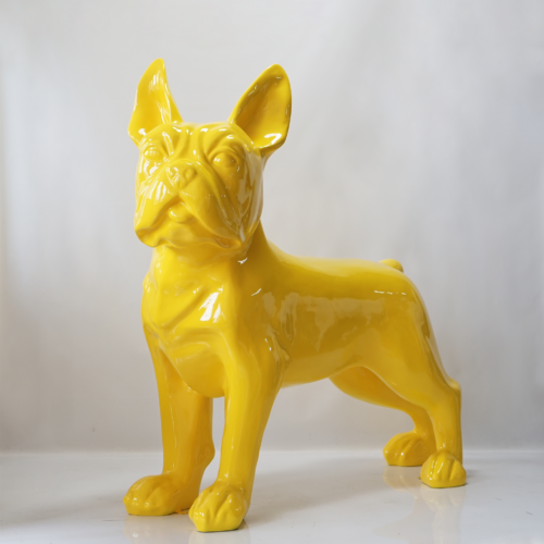 Yellow ceramic statue of a French Bulldog on a white background.