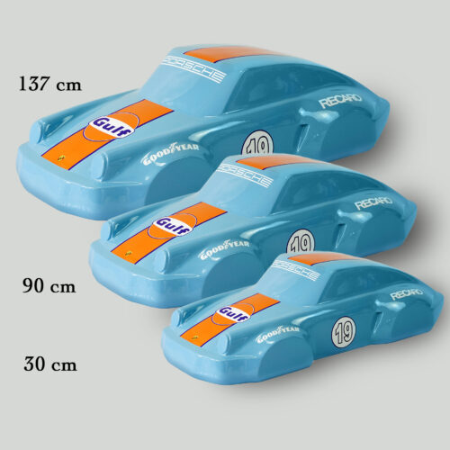 Three blue model cars with Gulf and Goodyear branding in different sizes (137 cm, 90 cm, and 30 cm) arranged in a descending order.